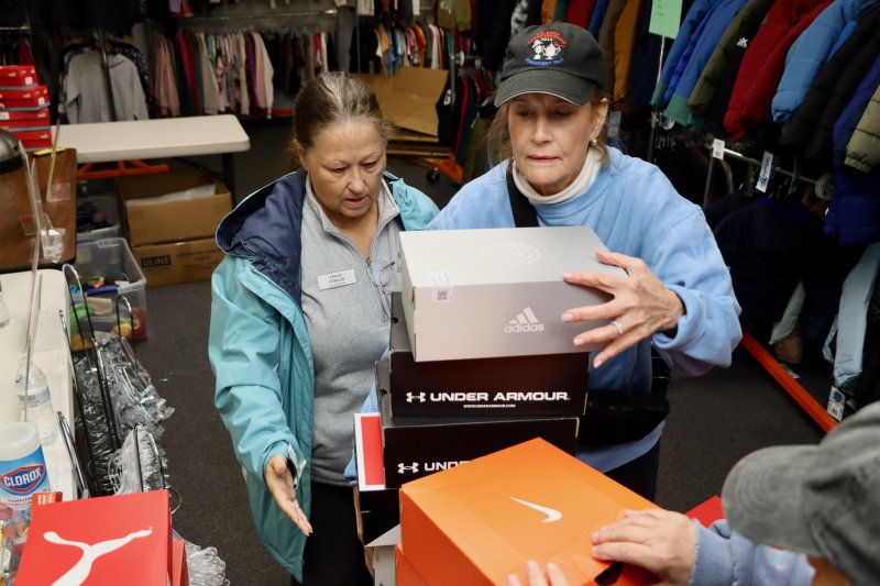 As fast as the sneakers come into the warehouse, Janice Fowler, left, and Janet Nardone get them on the shelves.